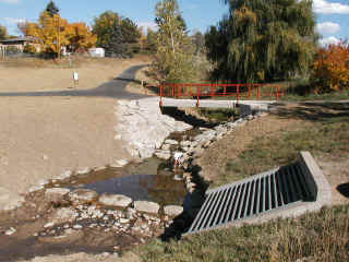 Little Dry Creek at Uinta Street  in Arapahoe County showing a completed drop structure and pedestrian bridge with an existing outfall structure in the foreground.